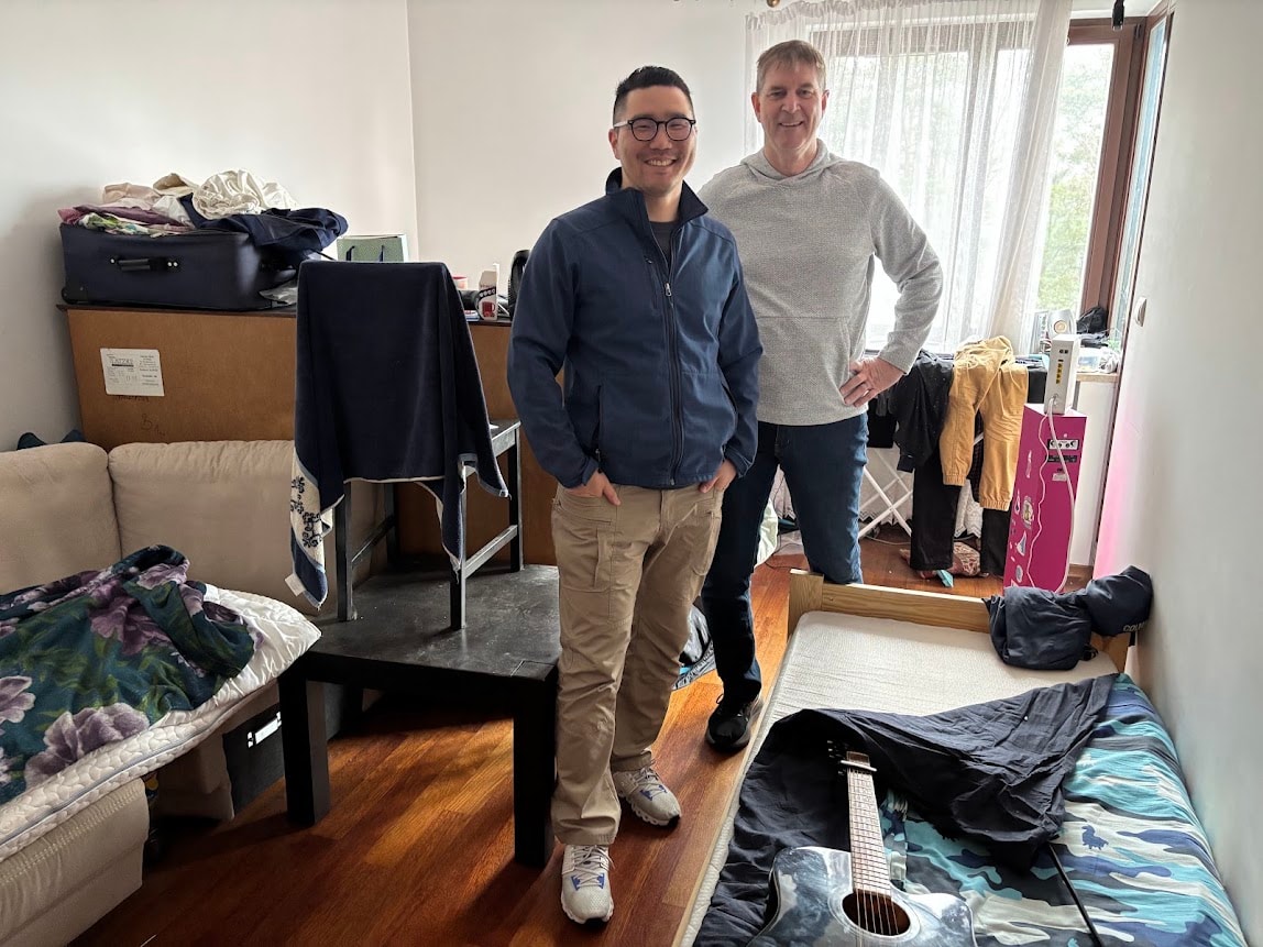 Byron Chae and Ed standing in a Ukrainian refugee apartment in Poland
